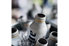 Image A miller lite aluminum bottle in an ice bucket.
